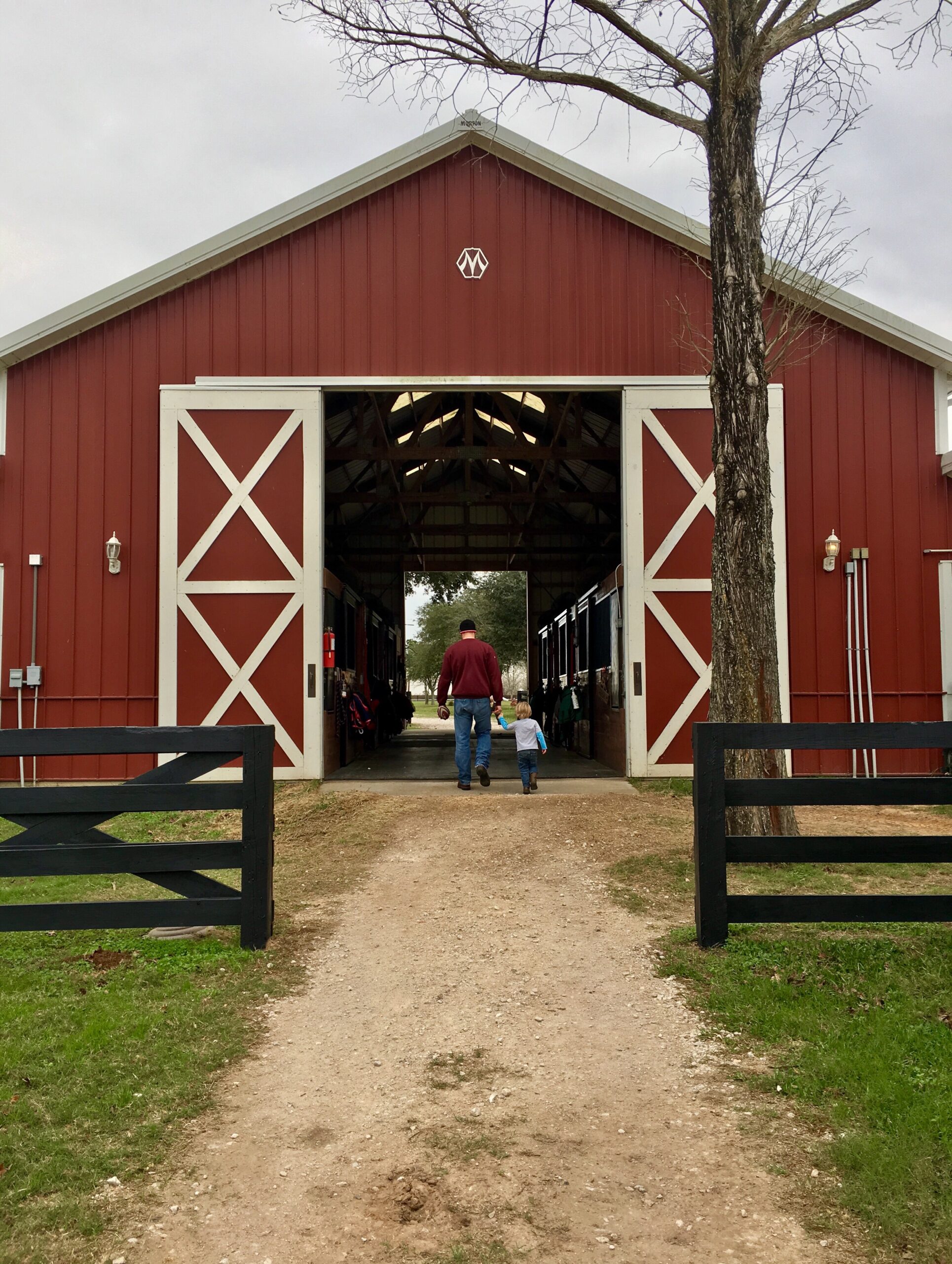 Barns Across Texas: Photo of father and son walking towards large barn.